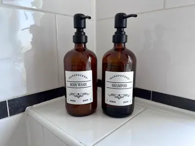two bottles of wine sitting on top of a counter at Award Winning Beautiful House in South Cambridge, 14-Min Drive to the City Centre, Free Parking, No Sofabeds, Sleeps 6 in Cambridge