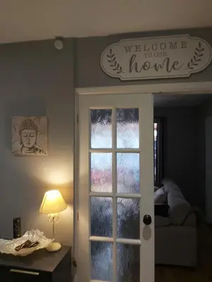 a welcome to our home sign above a door at Rose Garden Retreat in Rayleigh