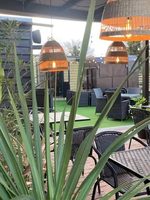 a patio with tables and chairs and plants at The Old Red Lion Inn in Cambridge