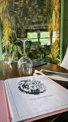 a table with a wine glass and a napkin at The Old Red Lion Inn in Cambridge