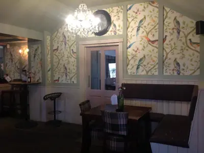 a dining room with a chandelier and a table at The Old Red Lion Inn in Cambridge