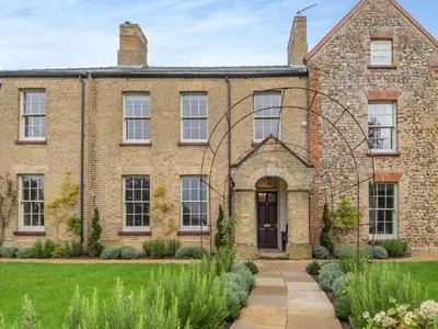 an old brick house with a garden in front of it at Abbey Barn Farmhouse in Marham