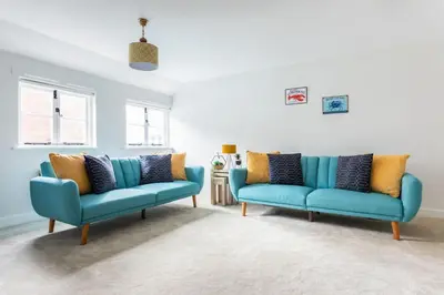 two blue couches in a living room at Maldon Executive Apartments in Maldon