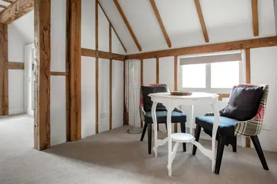a dining room with a table and chairs at Maldon Executive Apartments in Maldon