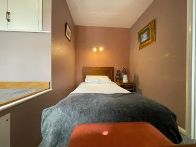 a small bedroom with a bed in the corner at The Prince of Wales in Huntingdon