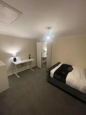 a bedroom with a bed and a desk in it at Relaxing double rooms in a beautiful house in Ipswich