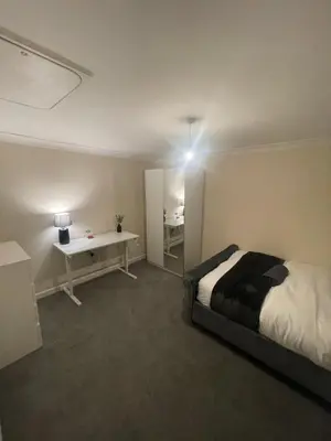 a bedroom with a bed and a desk in it at Relaxing double rooms in a beautiful house in Ipswich