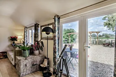 a living room with a door leading to a patio at 3 Bed in Sedge Fen oc-b28087 in Lakenheath