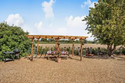 a picnic shelter with a table and a grill at 3 Bed in Sedge Fen oc-b28087 in Lakenheath