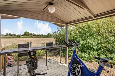 a blue bike parked on a porch with a table at 3 Bed in Sedge Fen oc-b28087 in Lakenheath