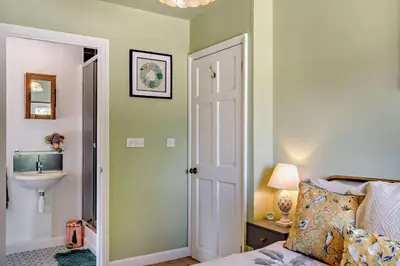 a bedroom with a bed and a sink and a bathroom at 3 Bed in Sedge Fen oc-b28087 in Lakenheath