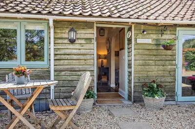a wooden house with a wooden table and a table sidx sidx sidx at 3 Bed in Sedge Fen oc-b28087 in Lakenheath