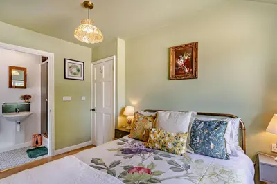 a bedroom with a bed and a chandelier at 3 Bed in Sedge Fen oc-b28087 in Lakenheath