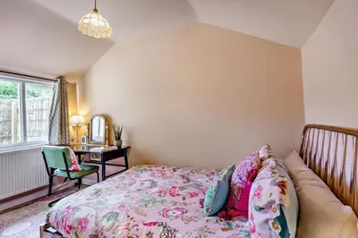 a bedroom with a bed and a desk and a window at 3 Bed in Sedge Fen oc-b28087 in Lakenheath