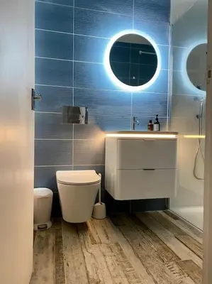 a bathroom with a sink and a toilet and a mirror at Gorgeous Comfy Cottage Walking Birdwatching Paddle Boarding and Seafood on the Doorstep in West Mersea