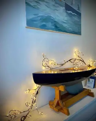 a bath tub in a room with a painting on the wall at Gorgeous Comfy Cottage Walking Birdwatching Paddle Boarding and Seafood on the Doorstep in West Mersea