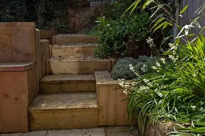 a set of stairs in a garden with plants at Gorgeous Comfy Cottage Walking Birdwatching Paddle Boarding and Seafood on the Doorstep in West Mersea