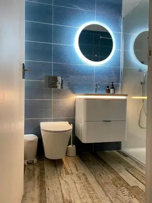 a bathroom with a sink and a toilet and a mirror at Gorgeous Comfy Cottage Walking Birdwatching Paddle Boarding and Seafood on the Doorstep in West Mersea