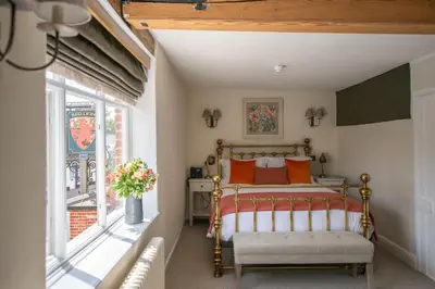 a bedroom with a bed and a window at The Red Lion in East Bergholt