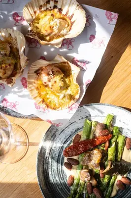 a table with a plate of food on a table at The Red Lion in East Bergholt
