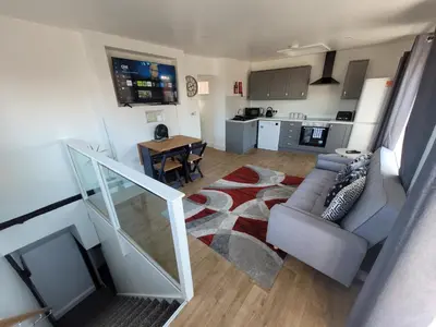 a living room with a couch and a table at City Centre Wallgate Apartments- Step back into Roman history in Colchester