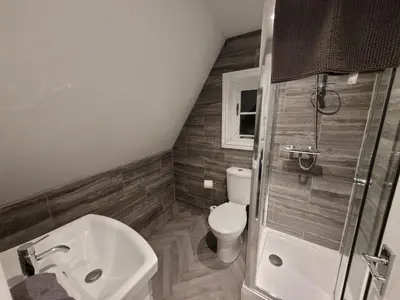 a bathroom with a toilet and a sink and a shower at City Centre Wallgate Apartments- Step back into Roman history in Colchester