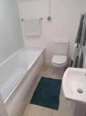 a bathroom with a shower and a toilet and a sink at Trinity, Central Cambridge Flat in Cambridge