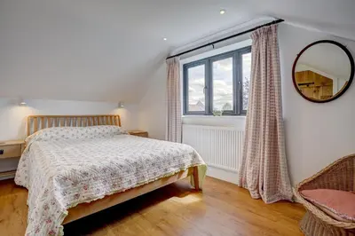 a bedroom with a bed and a window at Contemporary Barn Harleston Norfolk in Harleston