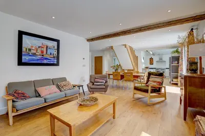 a living room with a couch and a table at Contemporary Barn Harleston Norfolk in Harleston