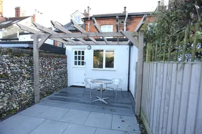 a patio with a table and a fence at Cottage, Central Saffron Walden, Garden, Little Braybrooke in Saffron Walden