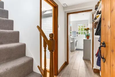 a hallway with stairs leading into a home with a mirror at Cottage, Central Saffron Walden, Garden, Little Braybrooke in Saffron Walden