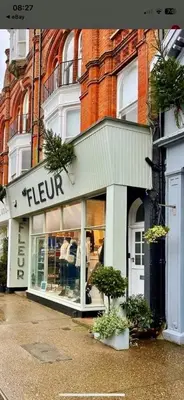 a store with a sign on the front of a building at Beautiful Immaculate Aldeburgh cottage, free parking, sunny outdoor space, dog friendly - perfect for Spring seaside escapes in Aldeburgh