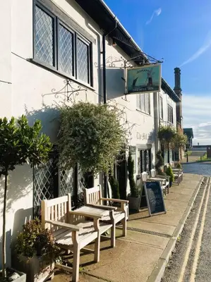 a group of benches sitting outside of a building at Beautiful Immaculate Aldeburgh cottage, free parking, sunny outdoor space, dog friendly - perfect for Spring seaside escapes in Aldeburgh