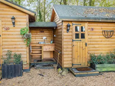 a wooden cabin with a sink and a door at Lion House- Uk45705 in Brinkley