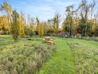 a picnic table in the middle of a field at Bear House- Uk45704 in Brinkley