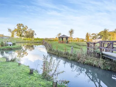 a river with a gazebo next to a bridge at Beavers- Uk45706 in Cambridge