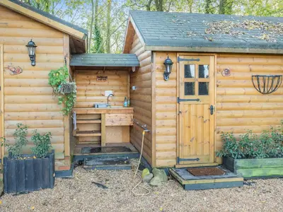 a wooden cabin with a sink and a door at Beavers- Uk45706 in Cambridge