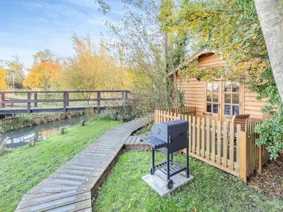 a barbecue grill in front of a log cabin at Beavers- Uk45706 in Cambridge