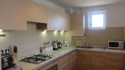 a kitchen with a sink and a stove top oven at Citystay Living - The Vie in Cambridge