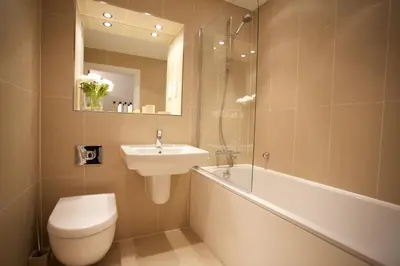 a bathroom with a sink and a toilet and a bath tub at Citystay Living - The Vie in Cambridge