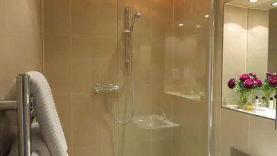 a bathroom with a shower with a glass door at Citystay Living - The Vie in Cambridge