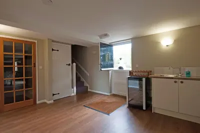 an empty kitchen with a sink and a counter at Marshlands House, Sleeps 16 - Country barn with hot tub in Woodbridge