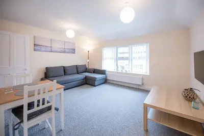a living room with a couch and a table at 1 & 2 Abbey Mews, Leiston in Leiston