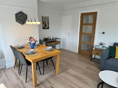 a dining room and living room with a table and chairs at Luxury Apartment in Letchworth in Letchworth