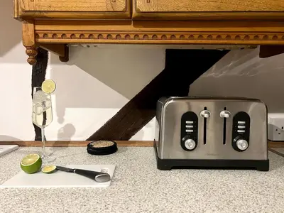 a toaster sitting on top of a counter next to a table at Duchess Apt 2 Modern 3Bedroom Apartment in Colchester Ideal for Long Stays, Relocations, Contractors, Secure Parking, WIFI in Colchester