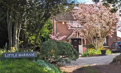 a brick house with a sign in front of it at Little Barham B&B in Wethersfield