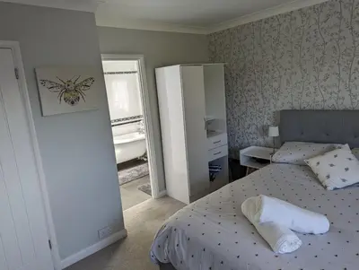 a small bedroom with a bed and a mirror at Little Barham B&B in Wethersfield