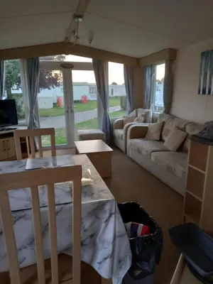 a living room with a couch and a table and chairs at Dovercourt holiday park swift johnson low road harwich essex co12 3TZ in Parkeston