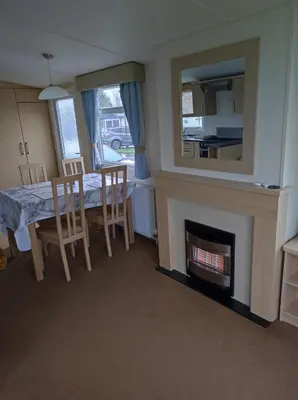 a dining room with a table and a fireplace at Dovercourt holiday park swift johnson low road harwich essex co12 3TZ in Parkeston