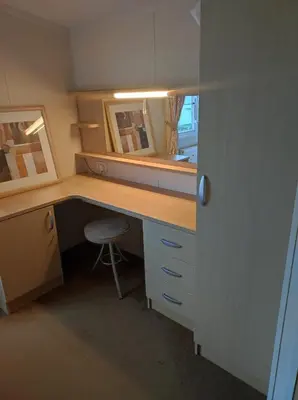 an office with a desk with a chair and a mirror at Dovercourt holiday park swift johnson low road harwich essex co12 3TZ in Parkeston